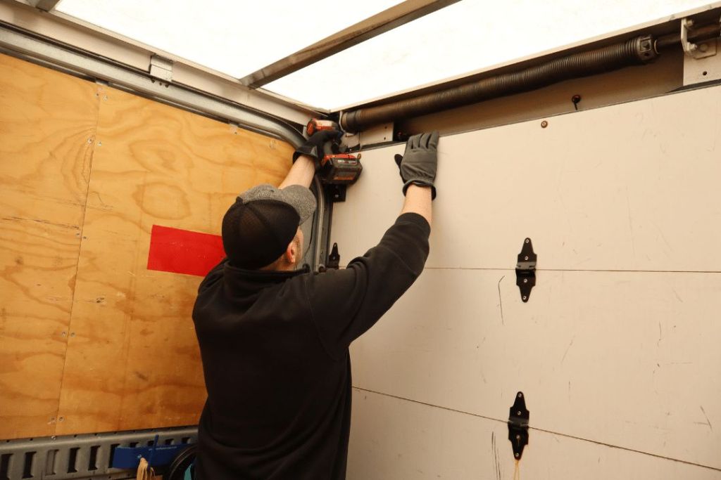 Technician repair a box truck door