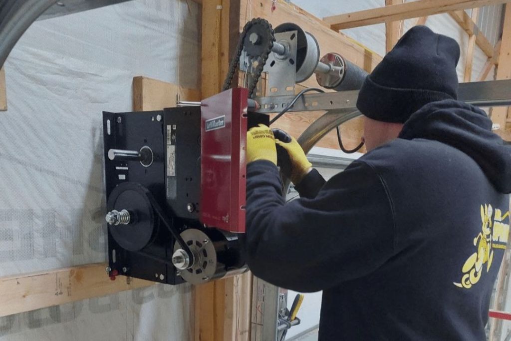 Technician repairing a garage door operator
