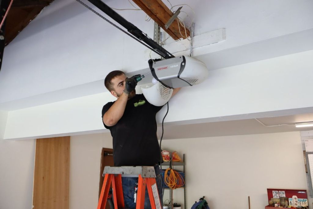 Technician repairing a garage door operator