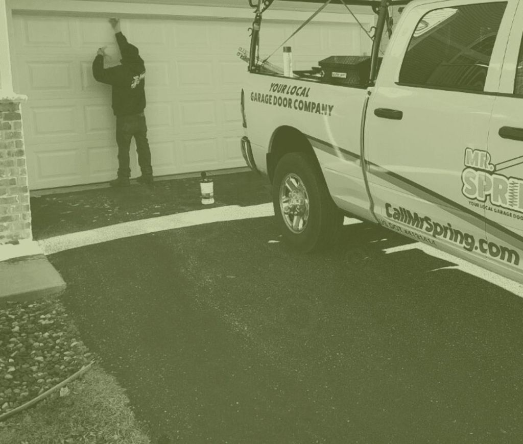 Technician doing maintenance on garage door