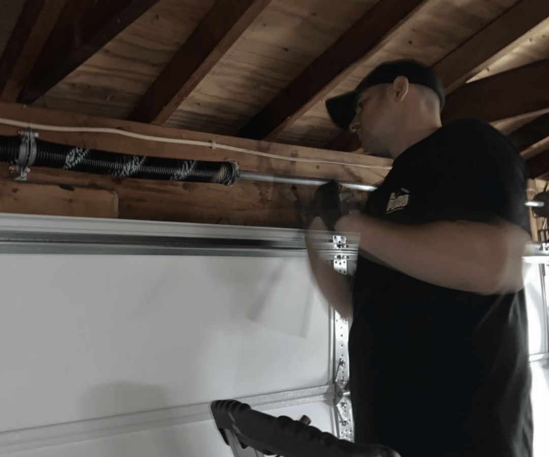 Technician replacing a garage door spring