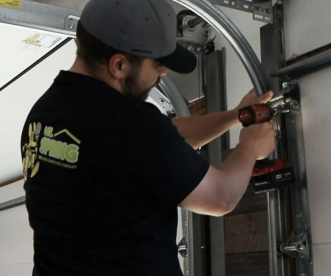 Employee working on garage door roller alignment