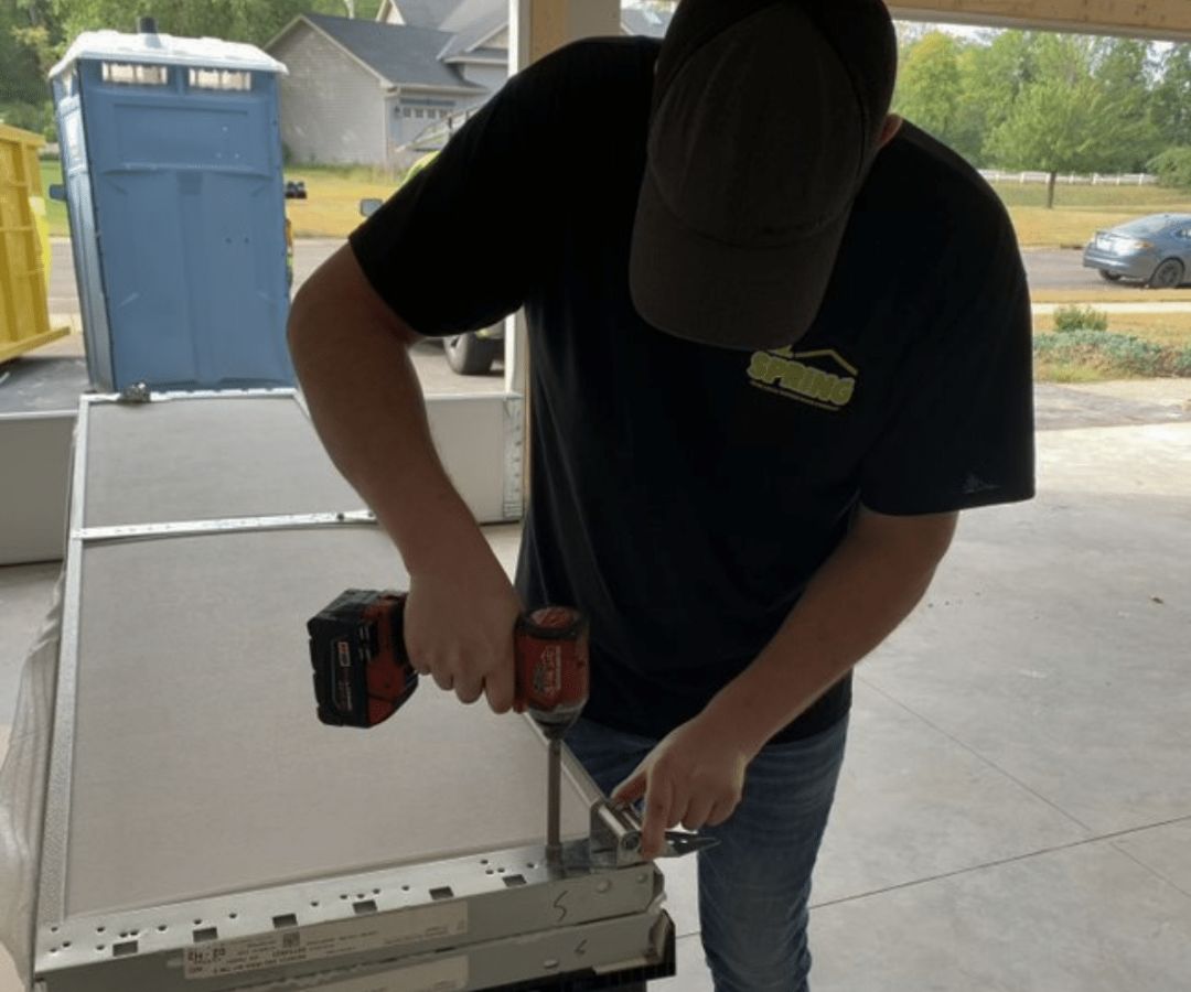 Employee fixing panel on garage door