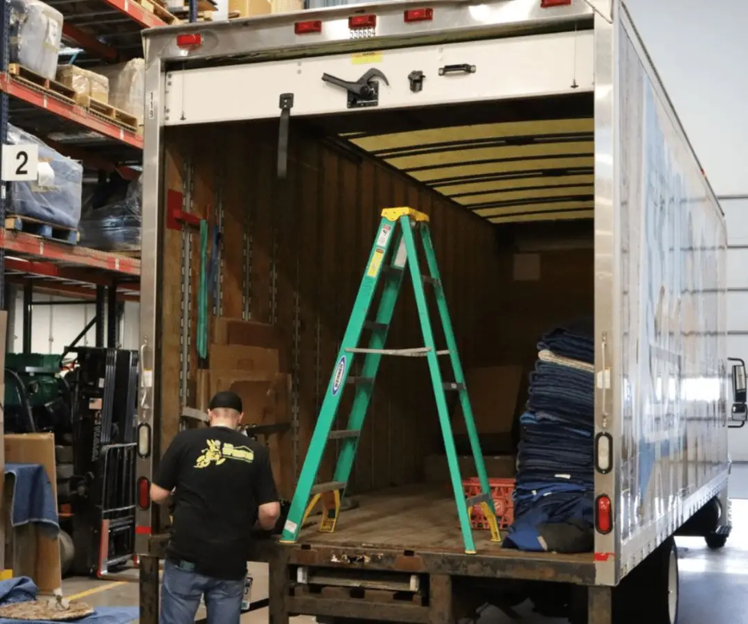 Technician working on a box truck door repair