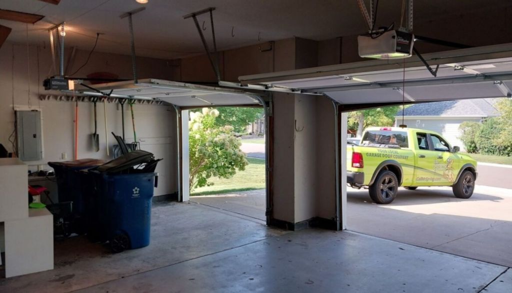 view of the inside of a garage with a mr spring garage doors branded truck parked outside