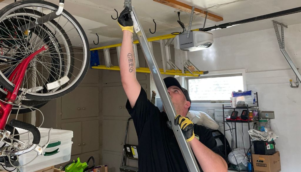 garage door technician installing a new garage door track