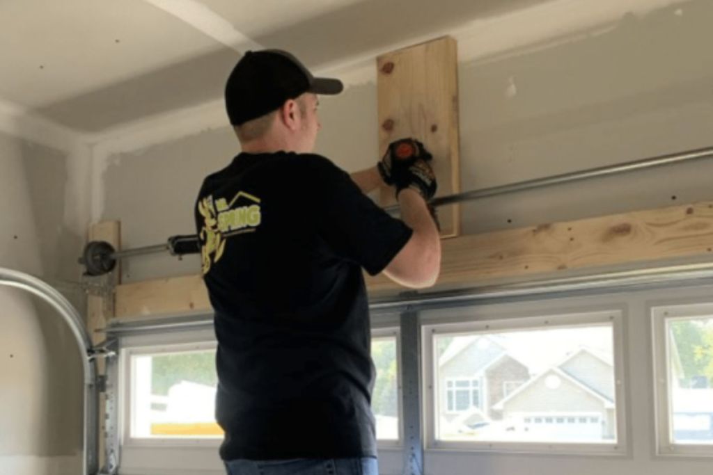 garage door technician repairing the garage of a home in saint cloud minnesota