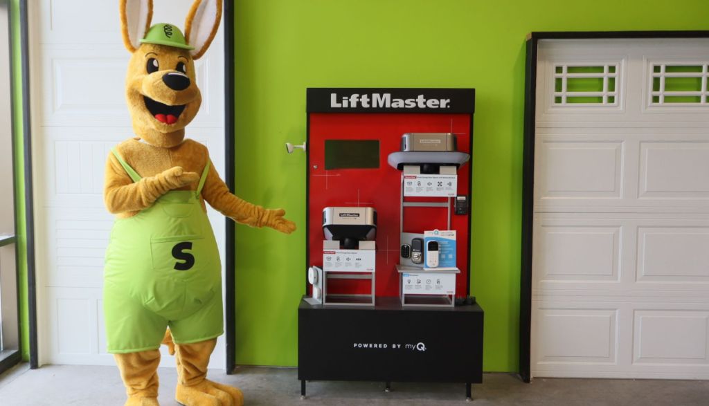The Mr. Spring kangaroo mascot showing off a garage door opener display