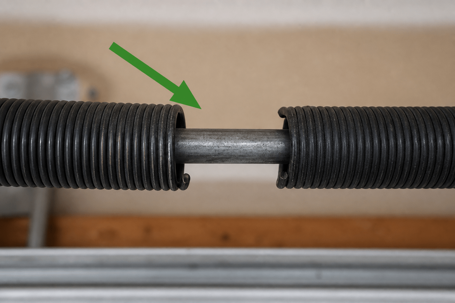 Broken garage door torsion spring showing a visible gap in the coil