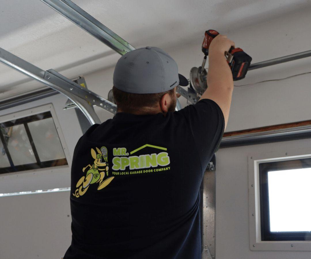 Garage Door Drum Repair, Minneapolis Mr. Spring technician repairing a garage door drum in Minneapolis